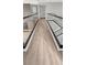 Hallway with glass railing overlooking an elegant living room and staircase at 11464 Beau Repost Dr, Orlando, FL 32832