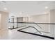 Bright hallway features glass and dark trim railing, light walls, and hardwood floors at 11464 Beau Repost Dr, Orlando, FL 32832