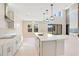 Modern kitchen featuring white cabinets, quartz countertops, stainless steel appliances, and a large island at 11464 Beau Repost Dr, Orlando, FL 32832