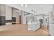 View of the open floor plan of the kitchen, living room, and staircase at 11464 Beau Repost Dr, Orlando, FL 32832