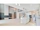 Spacious, open-concept living area with a modern kitchen and staircase with glass railings at 11464 Beau Repost Dr, Orlando, FL 32832