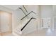 Modern staircase with glass railings and illuminated steps that leads to the second floor at 11464 Beau Repost Dr, Orlando, FL 32832