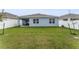 Spacious backyard with a covered patio and well-maintained lawn surrounded by a white fence at 1192 Sable Glen Dr, St Cloud, FL 34771