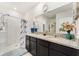 Spacious bathroom with double vanity, granite countertops, dark cabinets, walk-in shower, and modern finishes at 1192 Sable Glen Dr, St Cloud, FL 34771