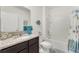 Bathroom featuring granite countertop, decorative fish accents, and shower with glass door at 1192 Sable Glen Dr, St Cloud, FL 34771