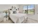Comfortable bedroom featuring a decorative headboard, window with blinds, and neutral color palette at 1192 Sable Glen Dr, St Cloud, FL 34771