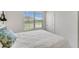 Bright bedroom features a large window and a comfortable bed with a patterned throw pillow at 1192 Sable Glen Dr, St Cloud, FL 34771