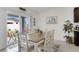 Well-lit dining area with a wooden table, chairs, sliding glass doors to the patio, and garden views at 1192 Sable Glen Dr, St Cloud, FL 34771