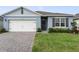 Well-maintained home with a two-car garage, brick-paved driveway, and neatly landscaped front yard at 1192 Sable Glen Dr, St Cloud, FL 34771