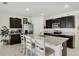Modern kitchen featuring a large island with counter seating, stainless steel appliances, and granite countertops at 1192 Sable Glen Dr, St Cloud, FL 34771