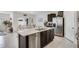 Bright kitchen with a center island, stainless steel appliances, dark cabinetry, and dining area leading to the backyard at 1192 Sable Glen Dr, St Cloud, FL 34771