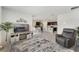 Bright and spacious living room with tile flooring, leading to the kitchen with a view of the island at 1192 Sable Glen Dr, St Cloud, FL 34771