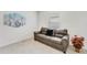 Cozy living room featuring a comfortable sofa, accent pillows, and natural light at 1192 Sable Glen Dr, St Cloud, FL 34771