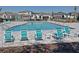 Community pool featuring lounge chairs, tables, and well-maintained landscaping at 1192 Sable Glen Dr, St Cloud, FL 34771