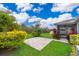 Landscaped backyard featuring a paved patio and lush green plants at 12191 Sumter Dr, Orlando, FL 32824