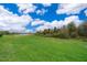Spacious backyard with a pond and grassy area, perfect for outdoor activities and relaxation at 12191 Sumter Dr, Orlando, FL 32824