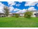 Well-maintained backyard with lush lawn, a screened-in porch, and privacy fencing at 12191 Sumter Dr, Orlando, FL 32824