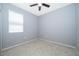 Neutral colored, empty bedroom with one window and a ceiling fan at 12191 Sumter Dr, Orlando, FL 32824