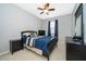 Bedroom with neutral colored carpet, ceiling fan and blue bedding at 12191 Sumter Dr, Orlando, FL 32824