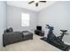 Bedroom furnished with a chaise lounge, TV, and an exercise bike at 12191 Sumter Dr, Orlando, FL 32824