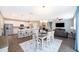 Dining area with ample seating and a view of the living room and adjacent kitchen at 12191 Sumter Dr, Orlando, FL 32824