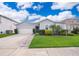 Charming single-story home with a well-maintained lawn, landscaping and a two-car garage at 12191 Sumter Dr, Orlando, FL 32824