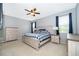 Comfortable bedroom featuring light-colored furniture, ceiling fan, and a window for natural light at 12191 Sumter Dr, Orlando, FL 32824
