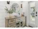 Light and airy bathroom featuring a wood vanity, round mirror, and white shiplap walls at 1404 Kelso Blvd, Windermere, FL 34786