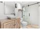 Stylish bathroom features a vessel sink, wood vanity, and glass-enclosed shower with neutral stone flooring at 1404 Kelso Blvd, Windermere, FL 34786