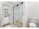 Bright bathroom featuring a tiled shower, white tile walls, and modern toilet at 1404 Kelso Blvd, Windermere, FL 34786