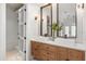 Stylish bathroom featuring double vanity, square sinks, wood cabinets, and framed mirrors at 1404 Kelso Blvd, Windermere, FL 34786