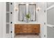 Modern bathroom features a double vanity with wood cabinets and decorative lighting at 1404 Kelso Blvd, Windermere, FL 34786