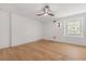 Bright, modern bedroom with hardwood floors, white shiplap wall, and a ceiling fan at 1404 Kelso Blvd, Windermere, FL 34786