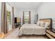 Bright bedroom boasts a neutral color scheme, large windows, stylish decor, and hardwood floors at 1404 Kelso Blvd, Windermere, FL 34786