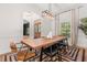Bright dining room features a wooden table, modern chandelier, and stylish rug at 1404 Kelso Blvd, Windermere, FL 34786