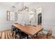 Bright dining room features a wooden table, modern chandelier, and view into stairway at 1404 Kelso Blvd, Windermere, FL 34786