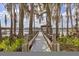 Picturesque private dock with spanish moss draped trees leading to the lake at 1404 Kelso Blvd, Windermere, FL 34786