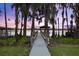 Waterfront access to dock, surrounded by mature trees and lush greenery providing a serene setting at 1404 Kelso Blvd, Windermere, FL 34786