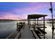 Picturesque dock with covered seating, offering stunning waterfront views and a relaxing atmosphere at 1404 Kelso Blvd, Windermere, FL 34786