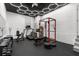 Home gym featuring black floor and ceiling, weight rack, bench and other fitness equipment at 1404 Kelso Blvd, Windermere, FL 34786