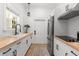 Kitchenette features a butcher block countertop, stainless steel refrigerator, and patterned rug at 1404 Kelso Blvd, Windermere, FL 34786