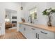 Kitchenette boasts a butcher block countertop, white cabinets, and view into the living room at 1404 Kelso Blvd, Windermere, FL 34786