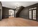 Spacious living room features hardwood floors, a modern chandelier, and dark accent wall at 1404 Kelso Blvd, Windermere, FL 34786