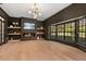 Stylish living room with modern fireplace, built-in shelves, and large windows at 1404 Kelso Blvd, Windermere, FL 34786