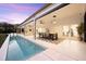 Inviting pool and patio area with an outdoor dining table, seating and seamless transition from indoor living at 1404 Kelso Blvd, Windermere, FL 34786