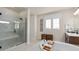 This bright bathroom offers a walk-in glass shower, dual sinks, and three decorative wall hangings at 15295 Rising View Dr, Montverde, FL 34756