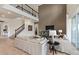Open-concept living room featuring high ceilings, a staircase, and comfortable white sofas at 15295 Rising View Dr, Montverde, FL 34756