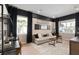 Comfortable media room featuring a large sofa, cinema decor, and ample natural light at 15295 Rising View Dr, Montverde, FL 34756
