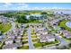 An aerial view of a community near a lake showcasing well-maintained properties and landscaping at 16027 Juniper Inlet Aly, Winter Garden, FL 34787