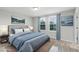 Staged bedroom features neutral walls, light gray wood-look flooring, and curated decor at 16027 Juniper Inlet Aly, Winter Garden, FL 34787